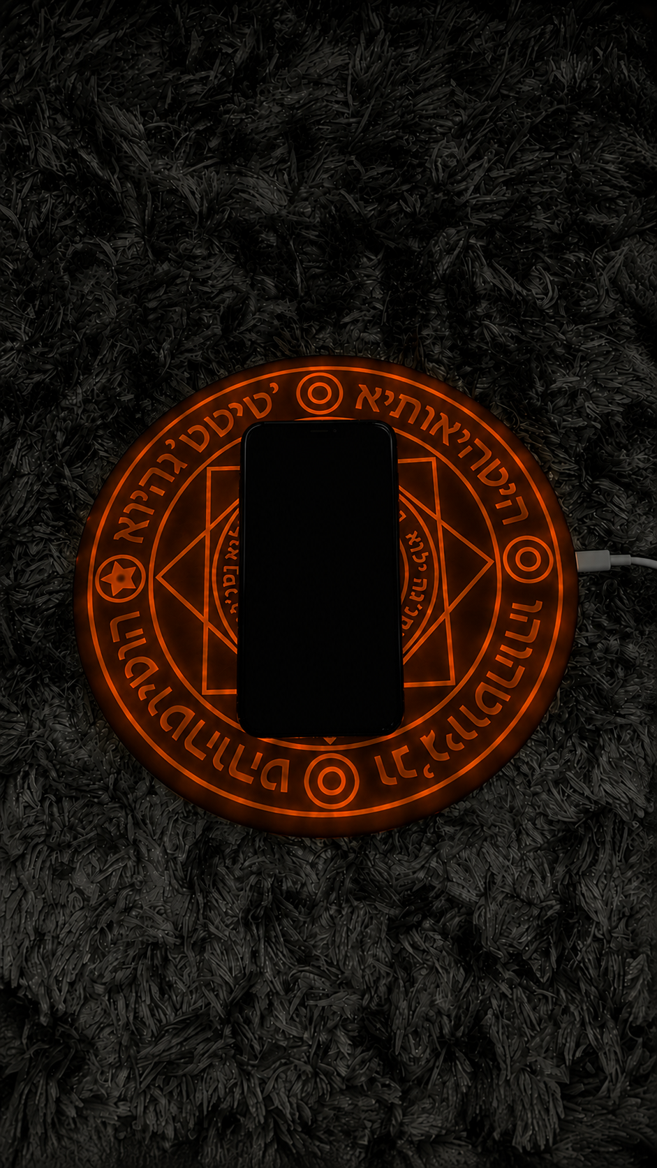 Phone charging on the glowing orange MYSTARA rune pad